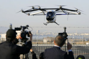 SkyDrive SD-05 eVTOL aircraft performing public demo flight at Osaka-Kansai Expo 2025, flying above the EXPO Vertiport.